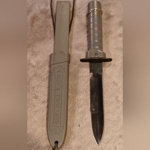 Bayonet style survival knife. Has compass little pack for matches and finger saw